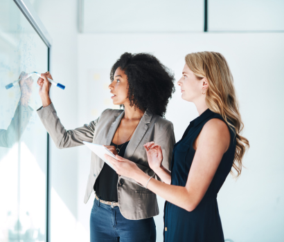 Two women on a team working together to develop brand strategy.