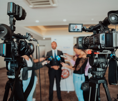 A news station interviews a local spokesperson as part of a public relations strategy.